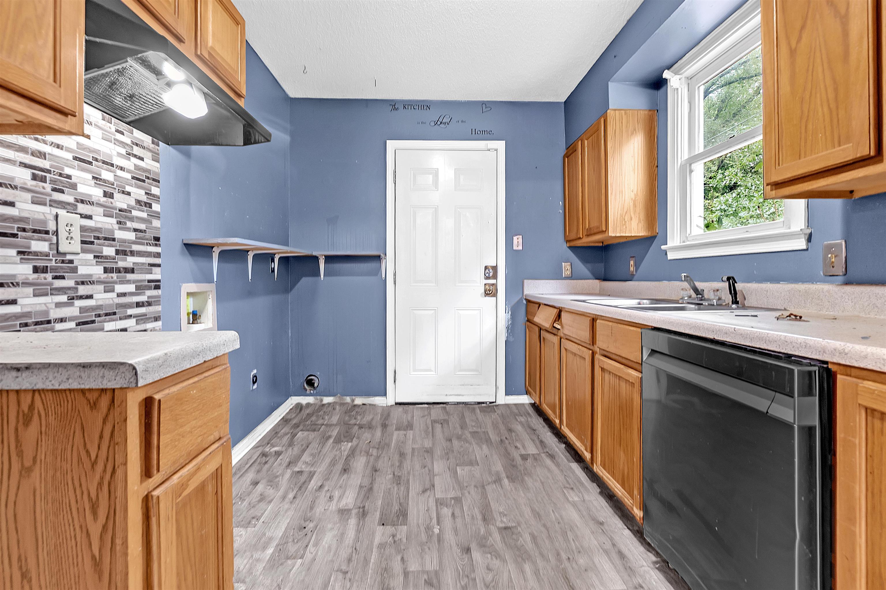 1013 Waring Road Memphis, TN 38122 - Photo 5 of 11 a kitchen with a sink stove and cabinets