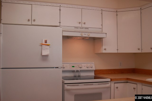 15450 Kivett Lane Reno, NV 89521 - Photo 4 of 9 a kitchen with appliances cabinets and a counter top