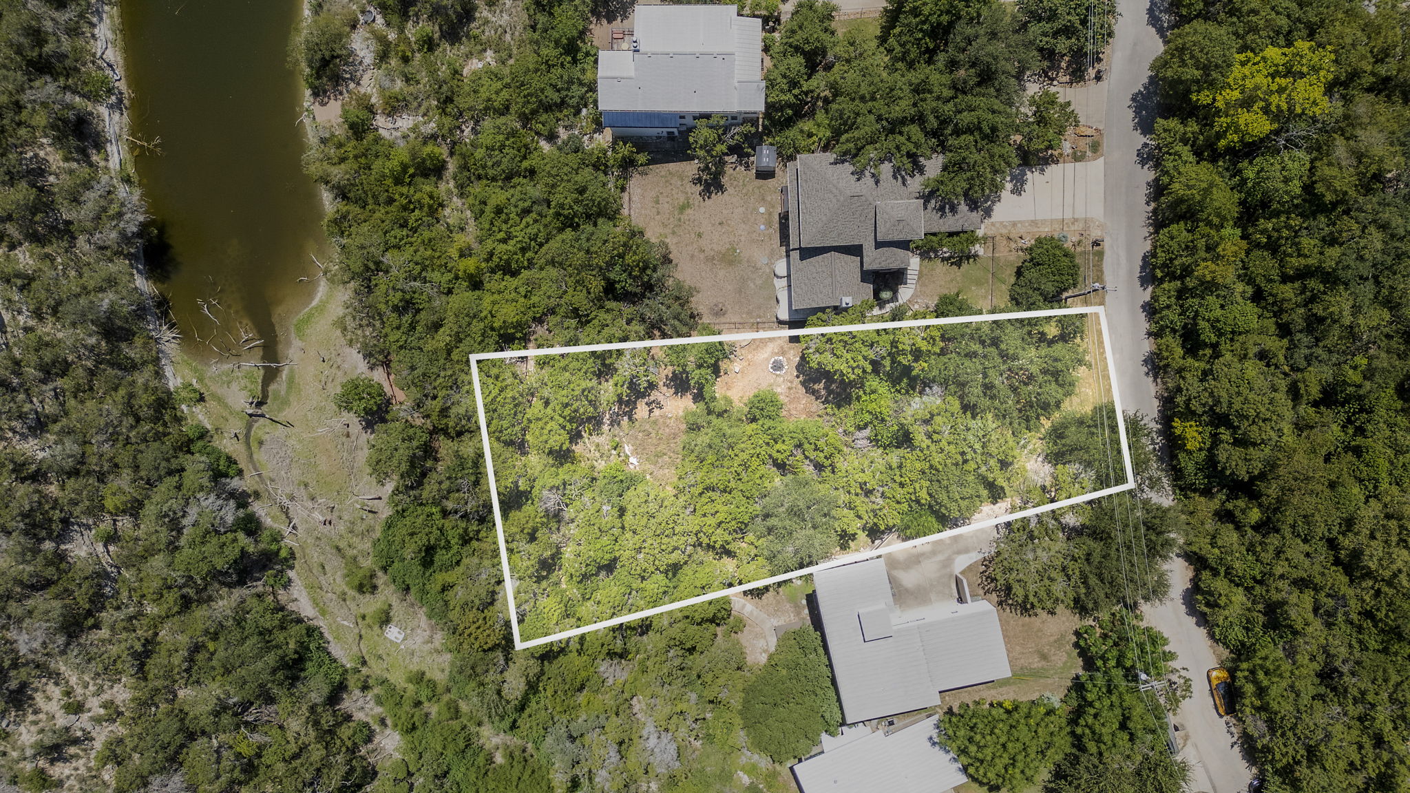 3013 Geronimo Trail Austin, TX 78734 - Photo 2 of 20 an aerial view of a house with a yard and lake view