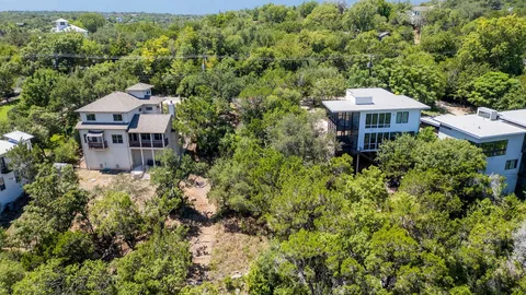 an aerial view of a house with a yard basket ball court and outdoor seating