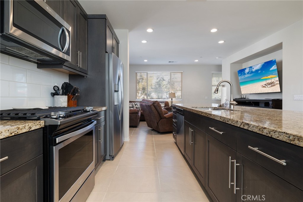 1200 Oliva Court Duarte, CA 91010 - Photo 5 of 40 a kitchen with stainless steel appliances granite countertop a stove a sink and a refrigerator