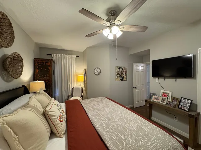 a bedroom with a bed and a flat screen tv