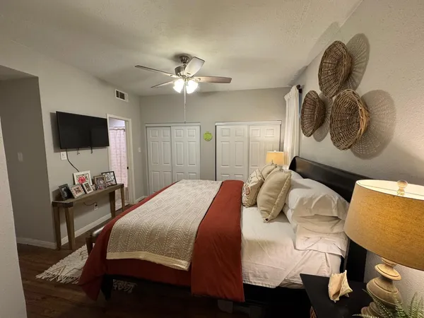 a bedroom with a bed and a flat screen tv