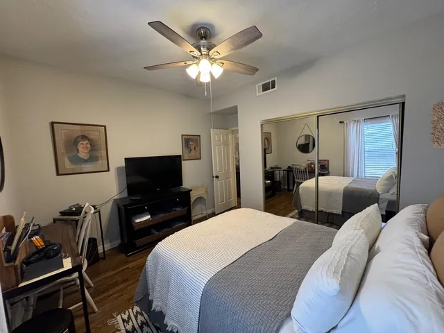 a bedroom with two beds and a flat screen tv