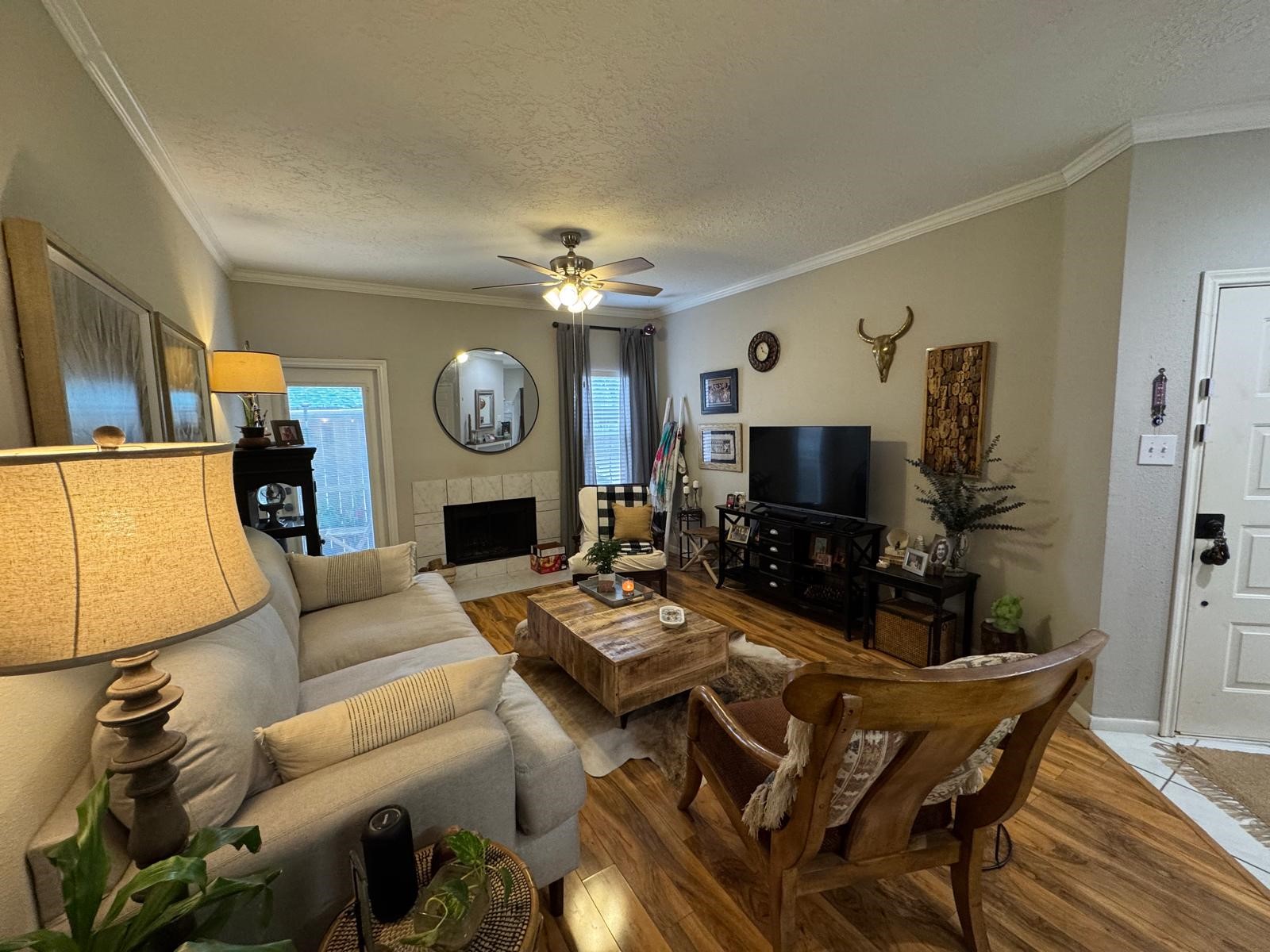2011 Spenwick Drive, Unit 511 Houston, TX 77055 - Photo 2 of 37 a living room with furniture a flat screen tv and a fireplace