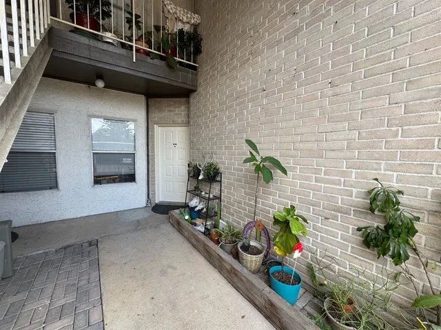 a view of entryway with flower pots