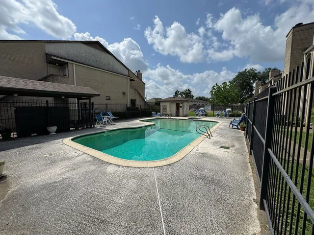 a view of a house with a swimming pool and a yard