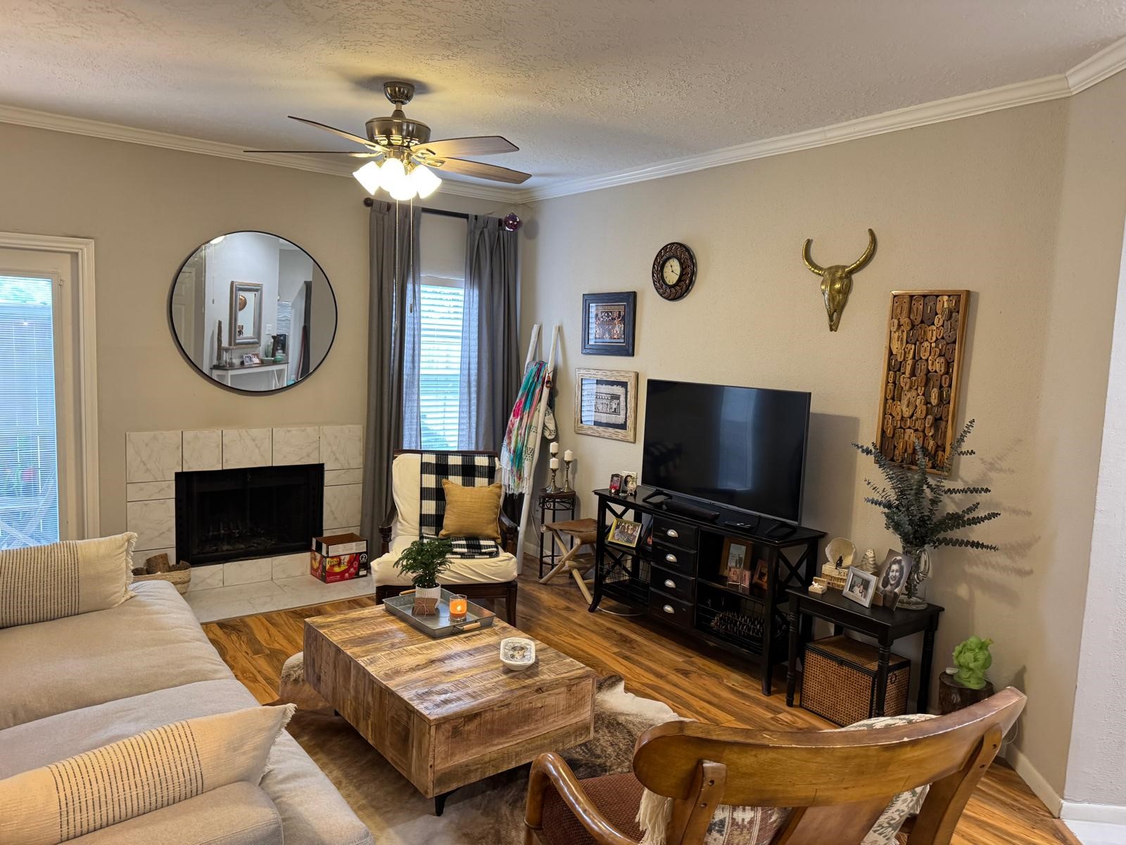 2011 Spenwick Drive, Unit 511 Houston, TX 77055 - Photo 3 of 37 a living room with furniture a fireplace and a flat screen tv
