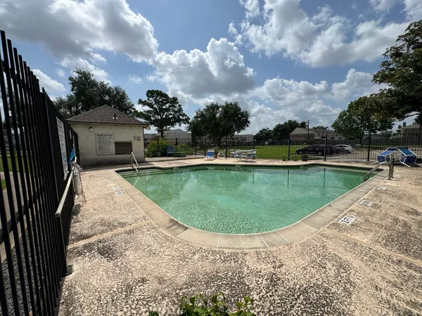 a view of a swimming pool with a yard