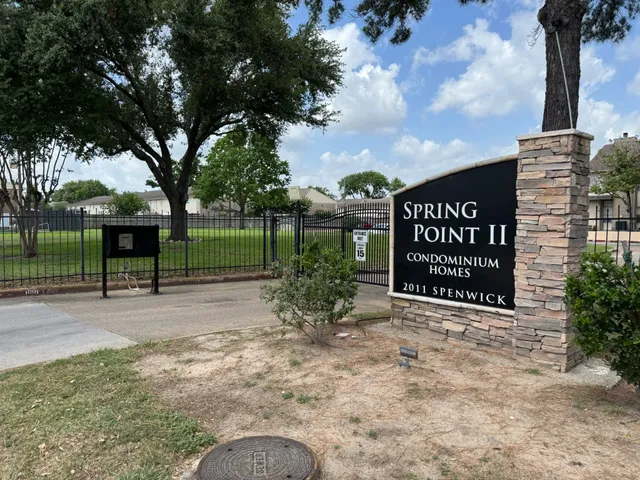 a view of a street sign under a large tree