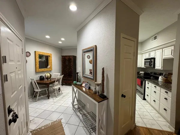 a living room with furniture a flat screen tv and large window