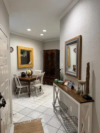 a living room with furniture a flat screen tv and a table