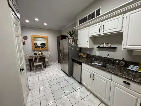 a kitchen with stainless steel appliances a stove a sink and a microwave