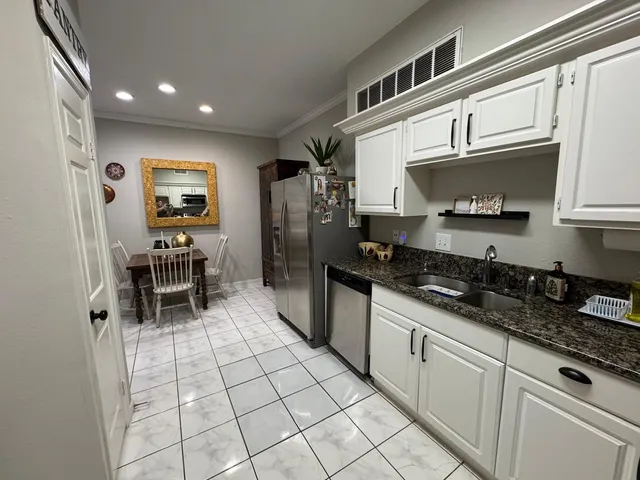 a kitchen with stainless steel appliances a stove a sink and a microwave
