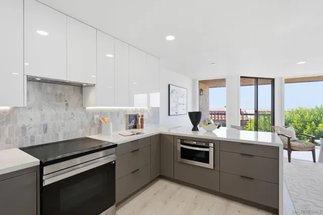 a kitchen with a sink appliances and cabinets