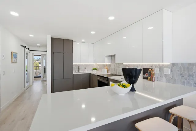 a bathroom with a double vanity sink and mirror with toilet