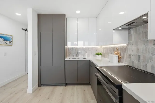 a bathroom with a granite countertop sink a toilet and a mirror