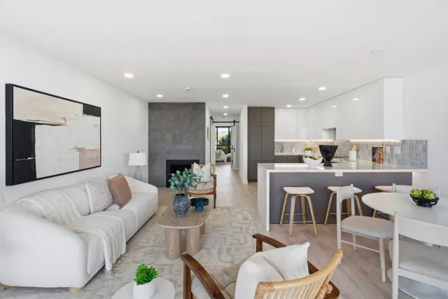 a kitchen with stainless steel appliances kitchen island granite countertop a stove a sink and a refrigerator