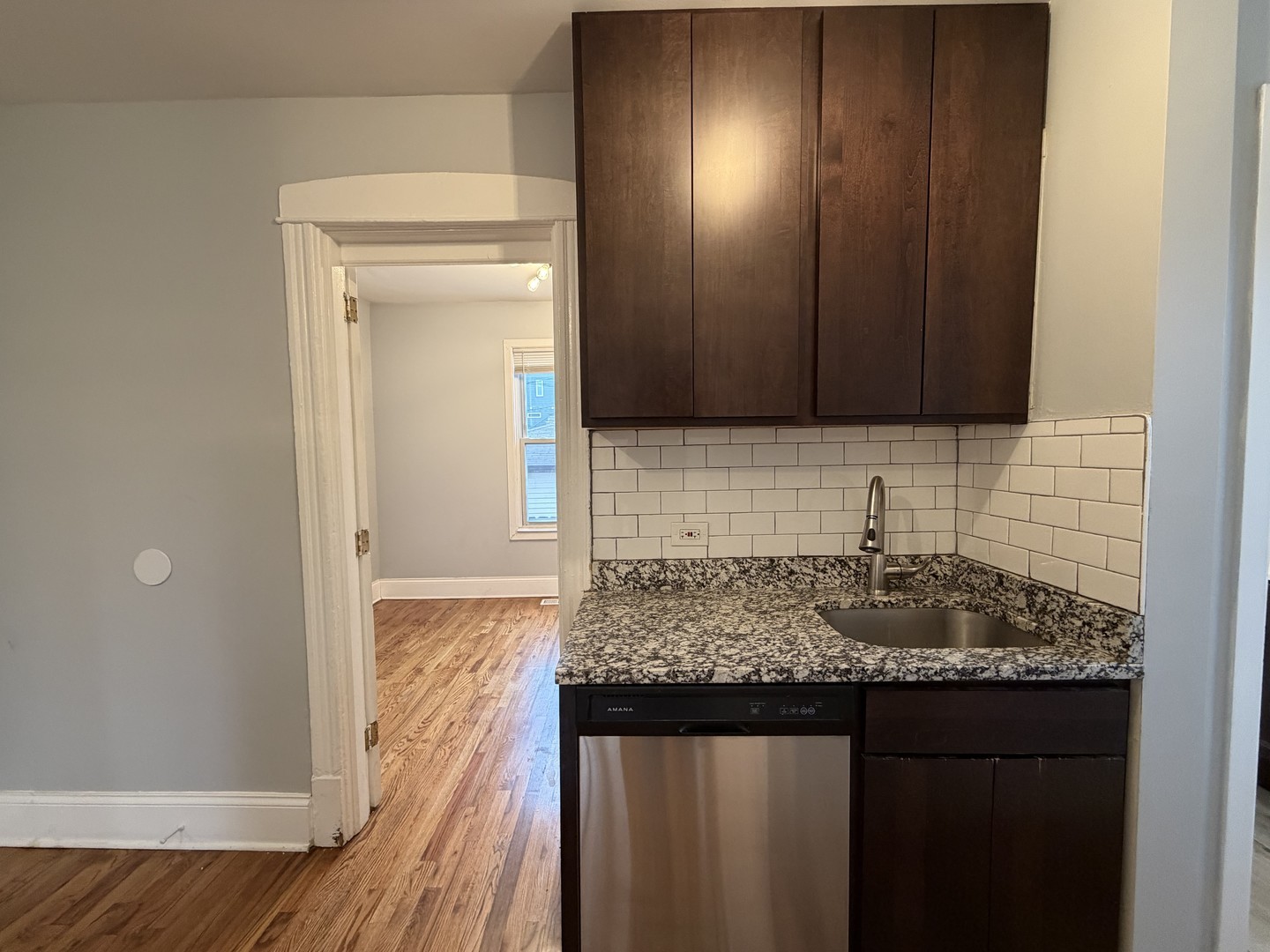 3614 West George Street, Unit 2R Chicago, IL 60618 - Photo 4 of 12 a bathroom with a granite countertop sink and a mirror