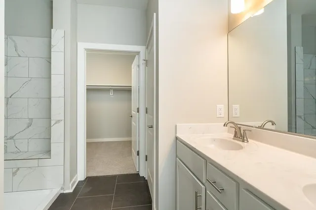 a bathroom with a shower sink and mirror