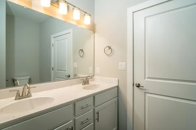 a bathroom with a double vanity sink mirror and
