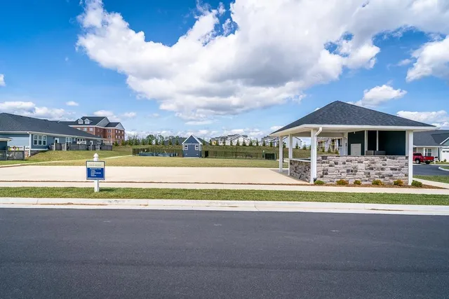 a view of swimming pool with outdoor seating and yard in back