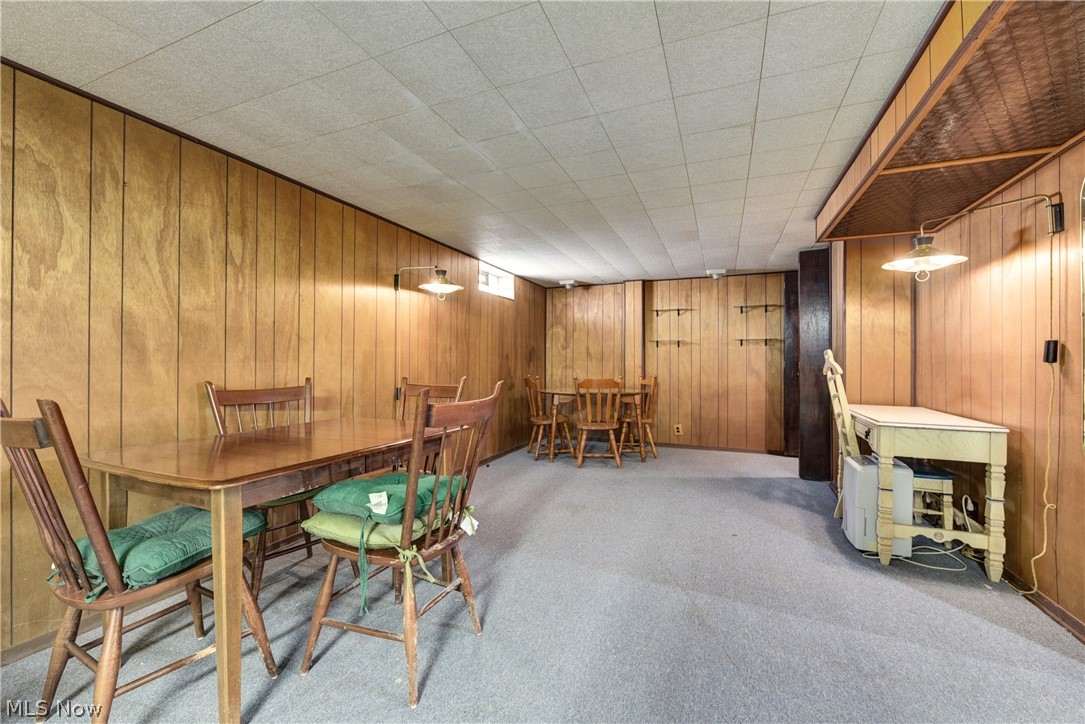 13617 Sheldon Road Cleveland, OH 44130 - Photo 22 of 36 Carpeted dining room with wood walls