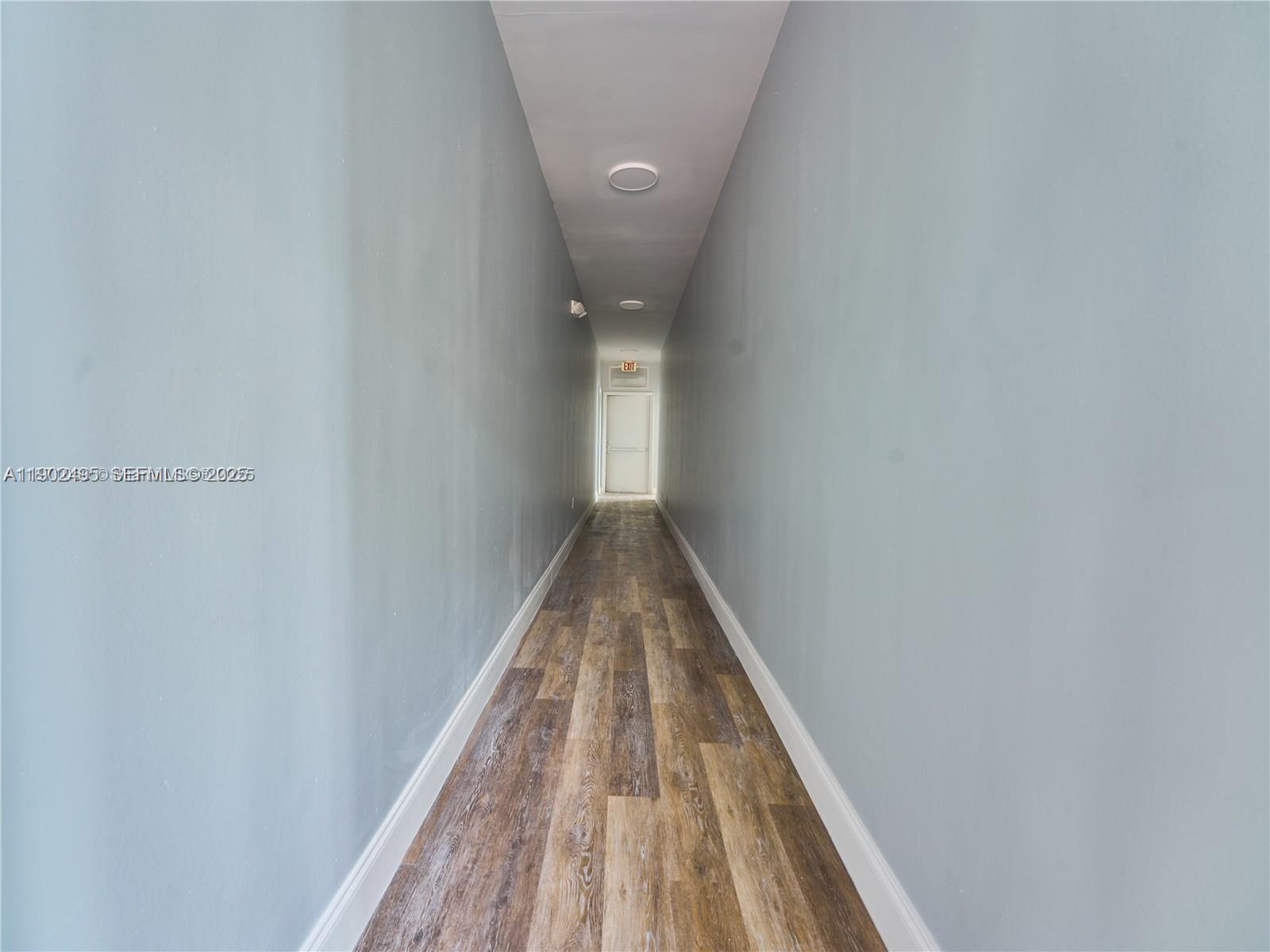 6211 Northwest 7th Avenue, Unit 4 Miami, FL 33150 - Photo 5 of 9 a view of a hallway with wooden floor