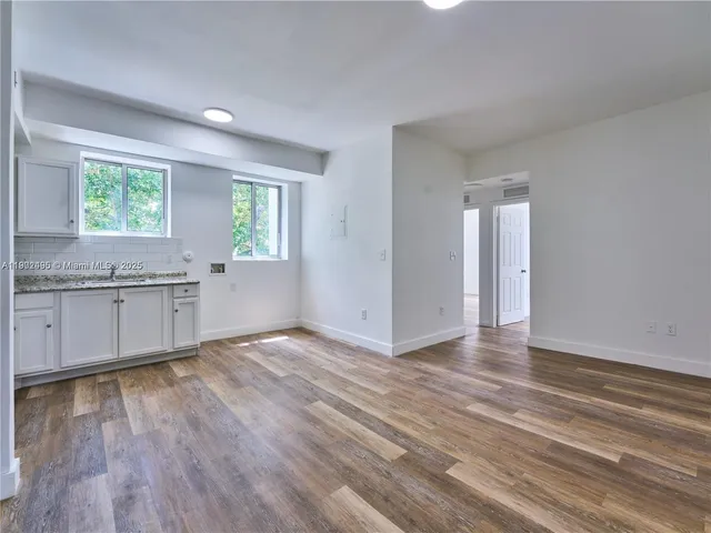 a view of a kitchen with a sink and a window