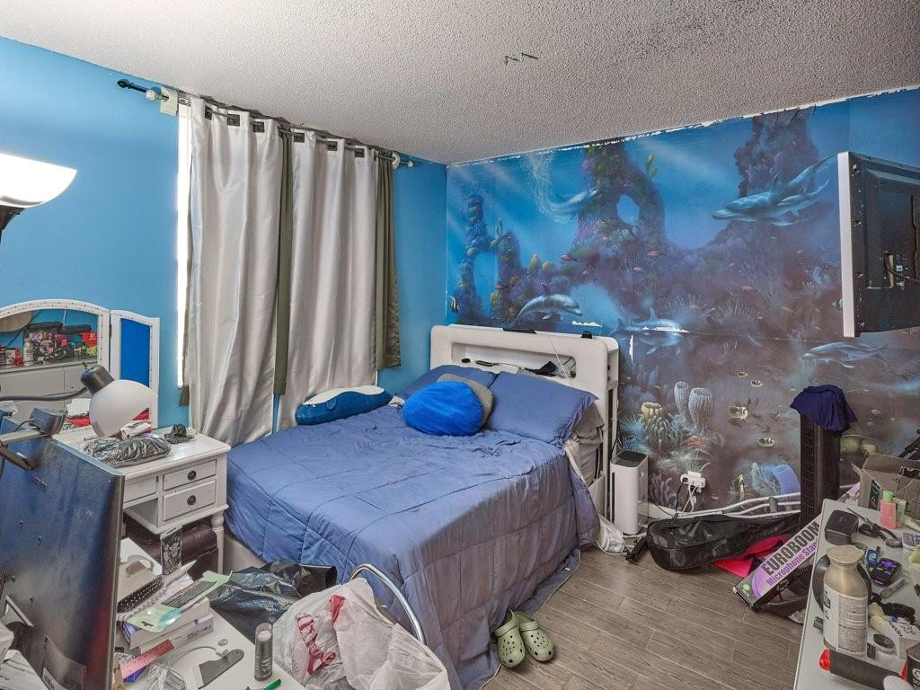 3253 Riverside Drive, Unit D301 Coral Springs, FL 33065 - Photo 11 of 29 a bedroom with a bed and a window