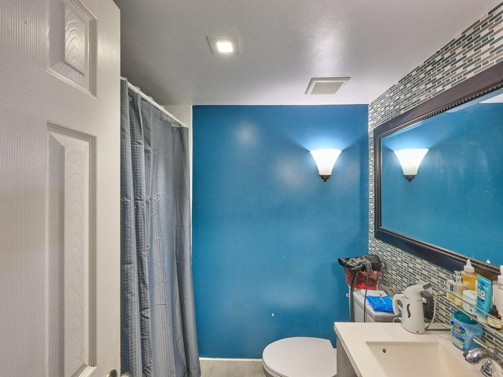 3253 Riverside Drive, Unit D301 Coral Springs, FL 33065 - Photo 15 of 29 a bathroom with a sink a toilet and shower curtain
