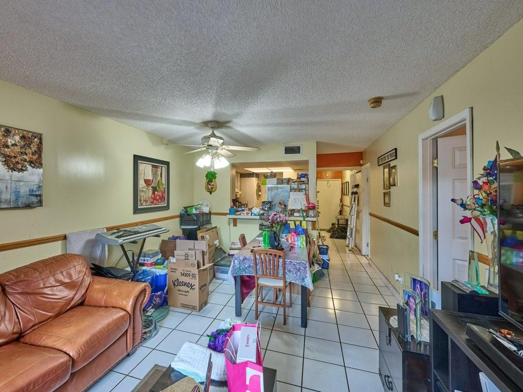 3253 Riverside Drive, Unit D301 Coral Springs, FL 33065 - Photo 21 of 29 a living room with furniture and a flat screen tv