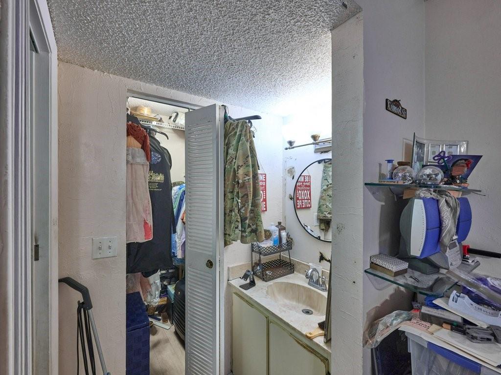 3253 Riverside Drive, Unit D301 Coral Springs, FL 33065 - Photo 25 of 29 a view of walk in closet with clothes and shoes