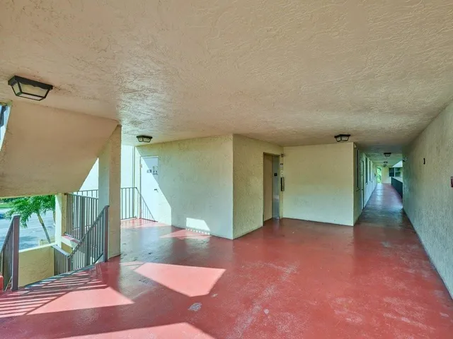 a view of a balcony with large windows