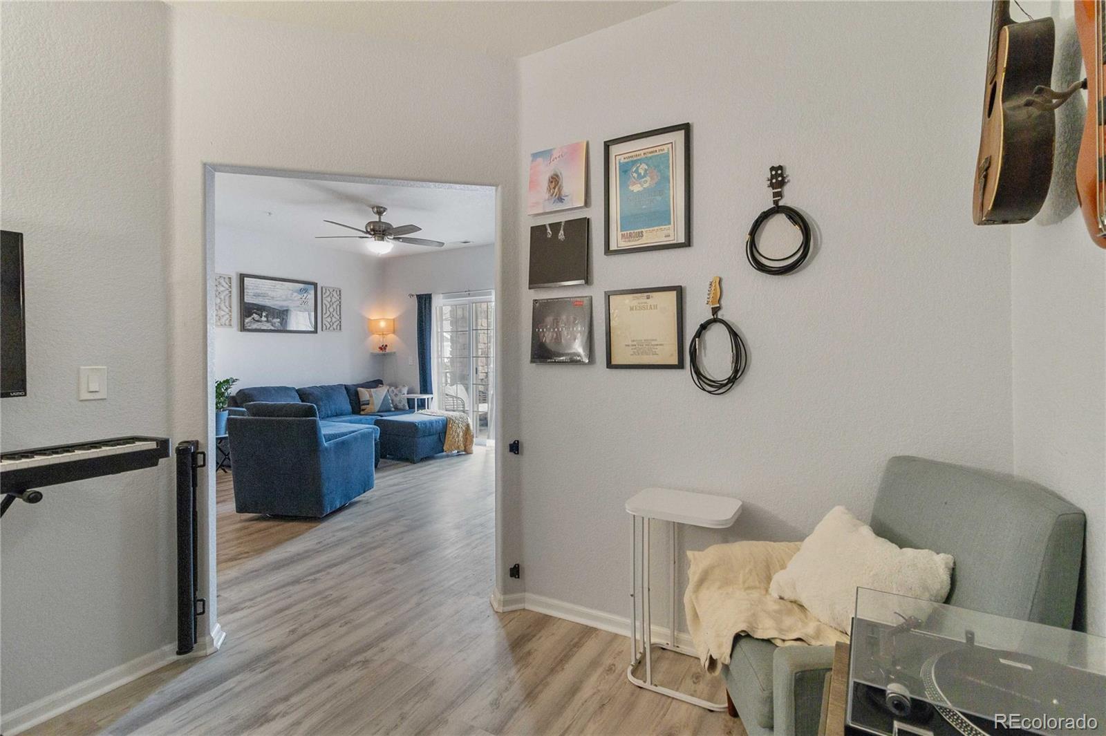 5255 Memphis Street, Unit 702 Denver, CO 80239 - Photo 12 of 30 a living room with furniture wooden floor and wall paintings