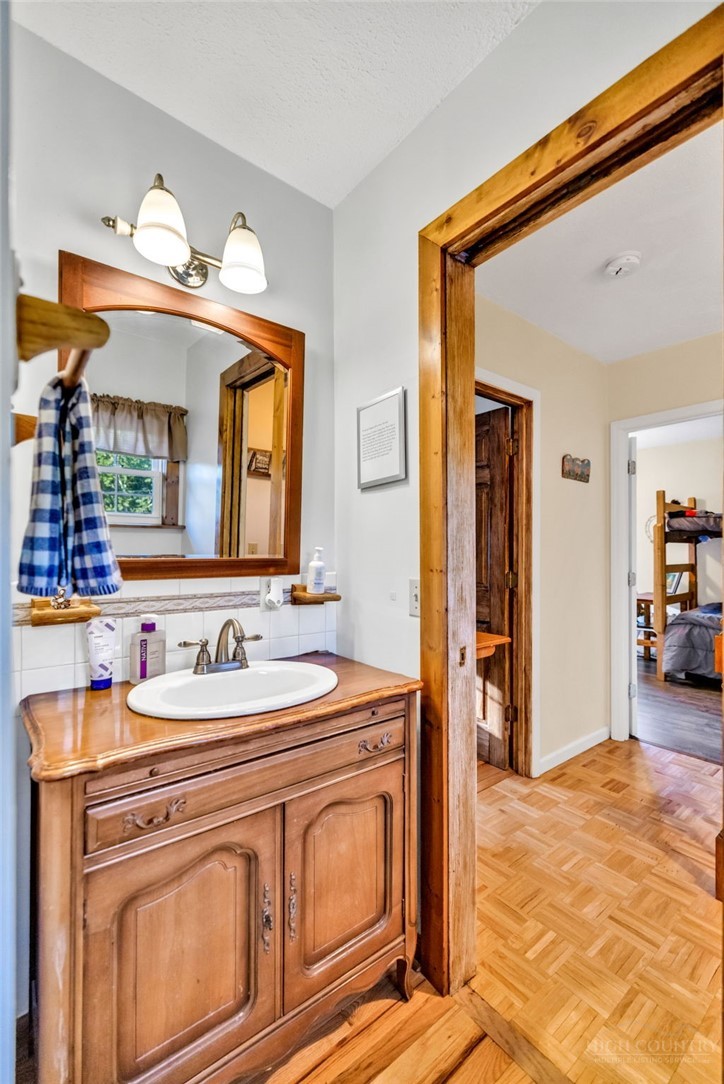 242 Ladd Parson Road Crumpler, NC 28617 - Photo 23 of 36 a bathroom with a sink and a mirror