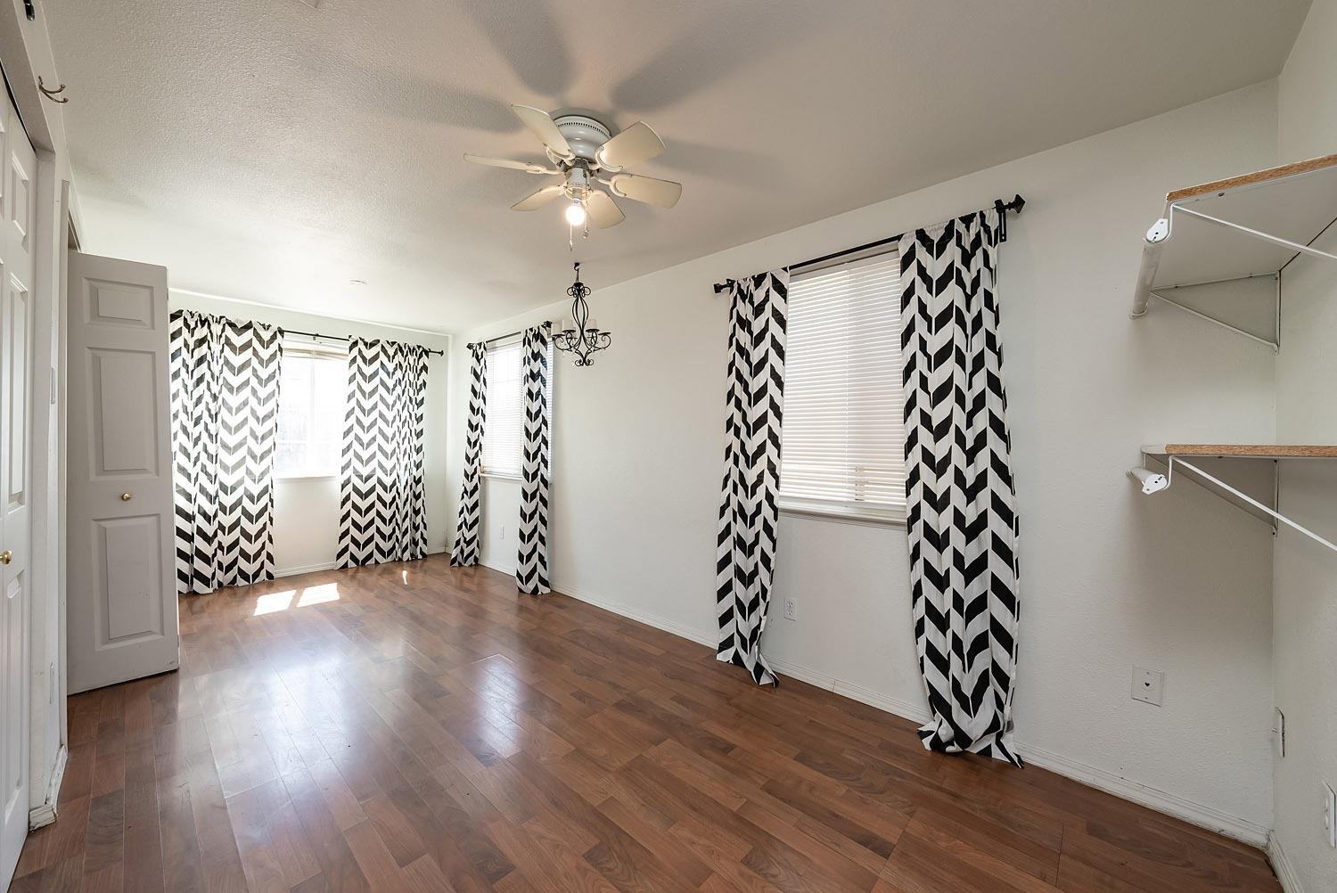 1841 Easy Street Hanford, CA 93230 - Photo 11 of 16 wooden floor in an empty room with a window