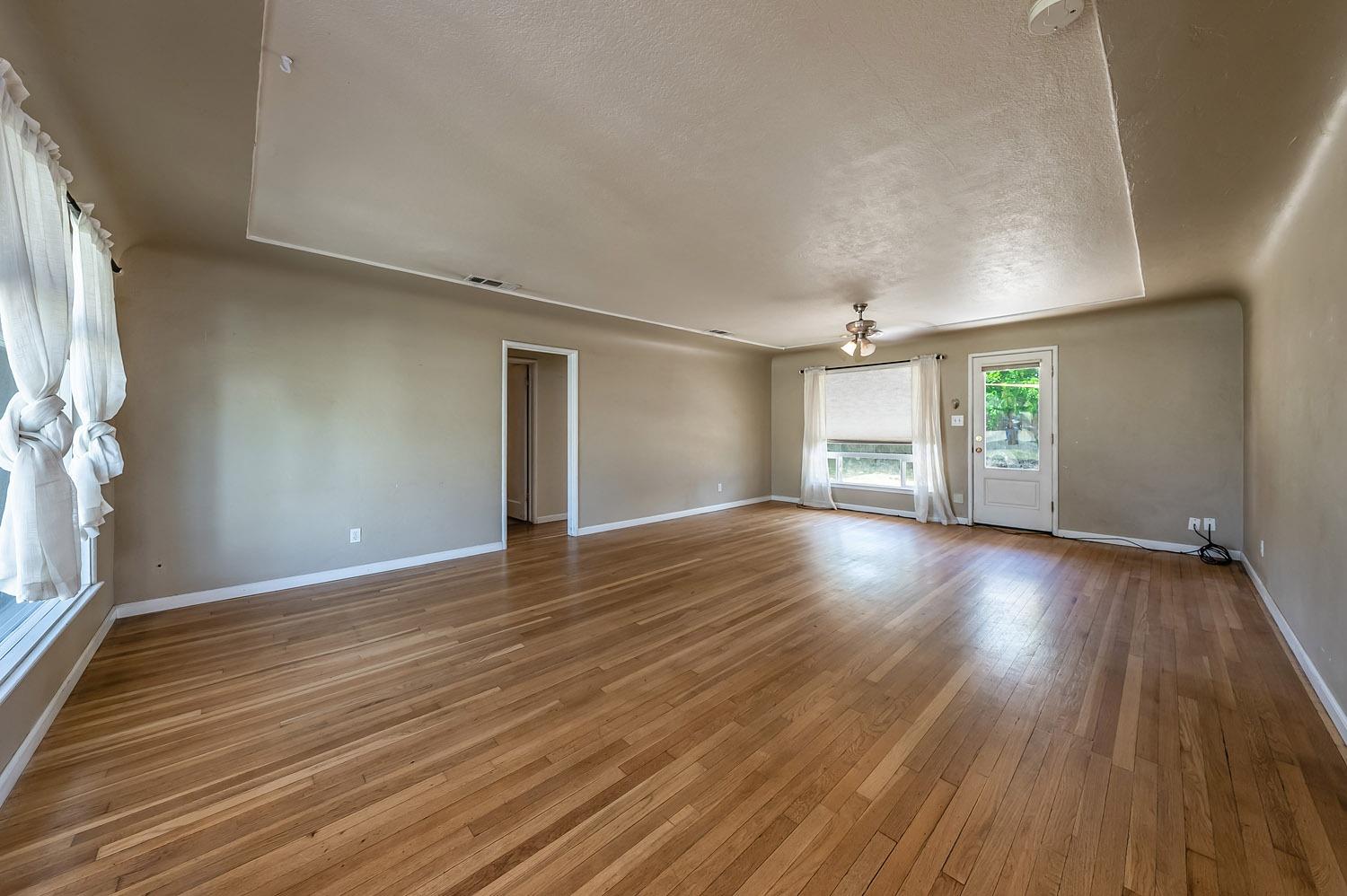 1841 Easy Street Hanford, CA 93230 - Photo 5 of 16 a view of an empty room with window and wooden floor