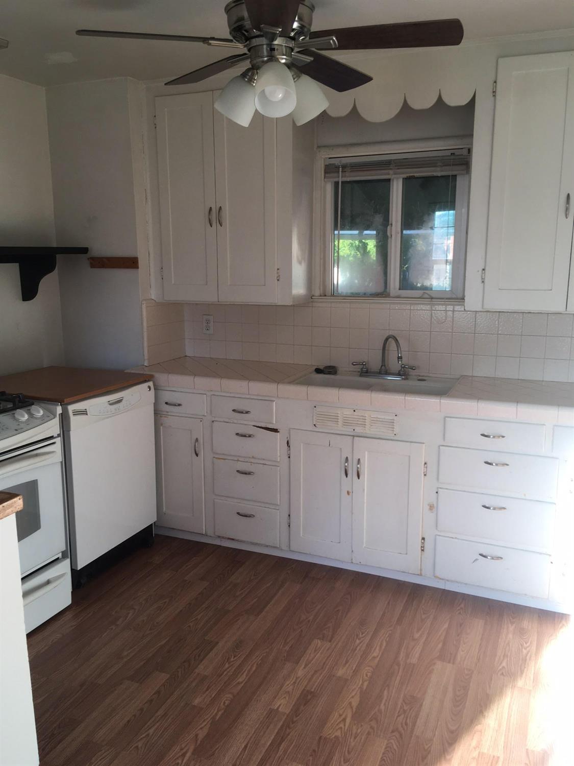 1841 Easy Street Hanford, CA 93230 - Photo 6 of 16 a kitchen with a sink cabinets and a window