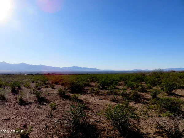 a view of a mountain range with trees in the background