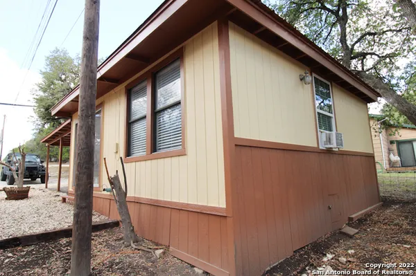 a view of house with backyard