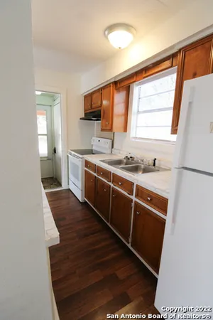 a kitchen with stainless steel appliances granite countertop a sink stove and cabinets
