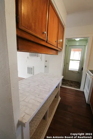 a view of an empty room and wooden floor