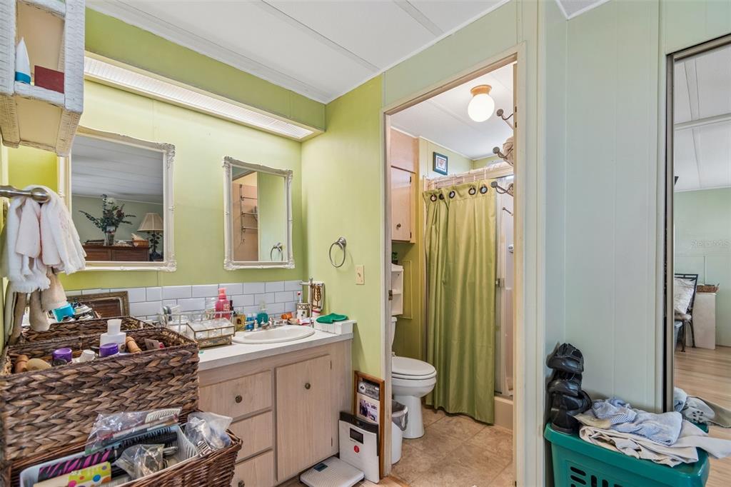 12501 Ulmerton Road, Unit 175 Largo, FL 33774 - Photo 17 of 32 a bathroom with a granite countertop sink and a mirror
