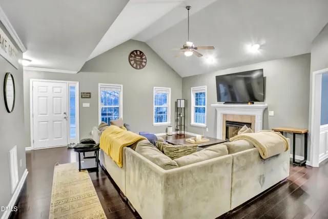 a living room with fireplace furniture and a flat screen tv