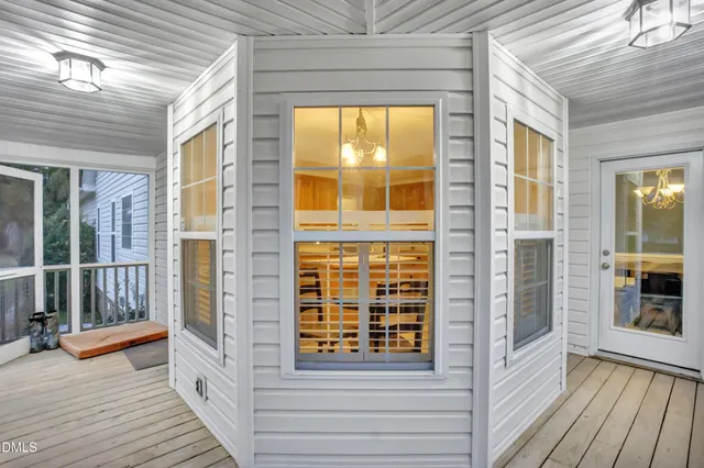 a view of a balcony with wooden floor and iron stairs