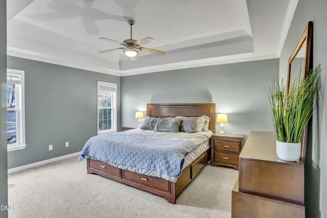 a bedroom with a bed and ceiling fan