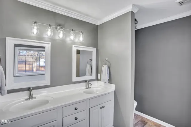a bathroom with a double vanity sink and a mirror