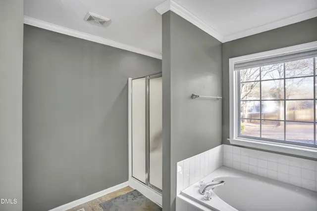 a bathroom with a tub and shower