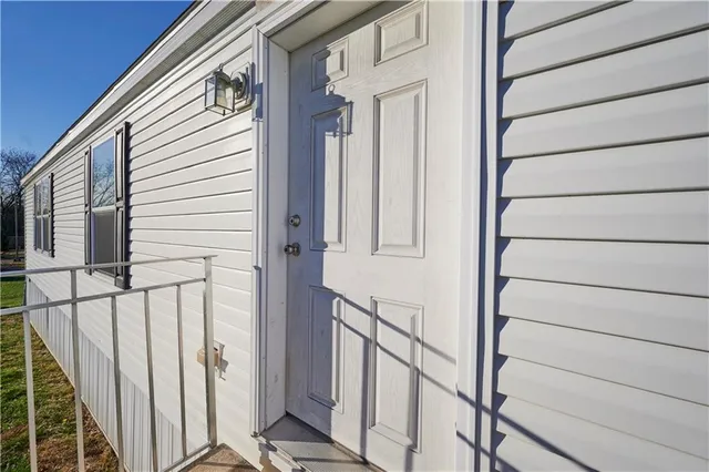 a view of a house with wooden floor and white walls